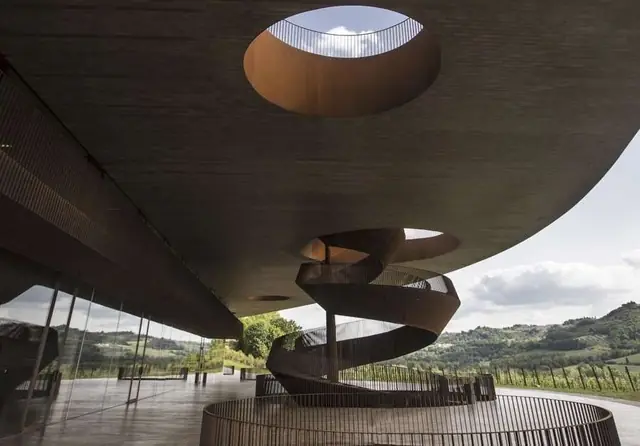 Sculptural winery architecture overlooking vineyards in Chianti