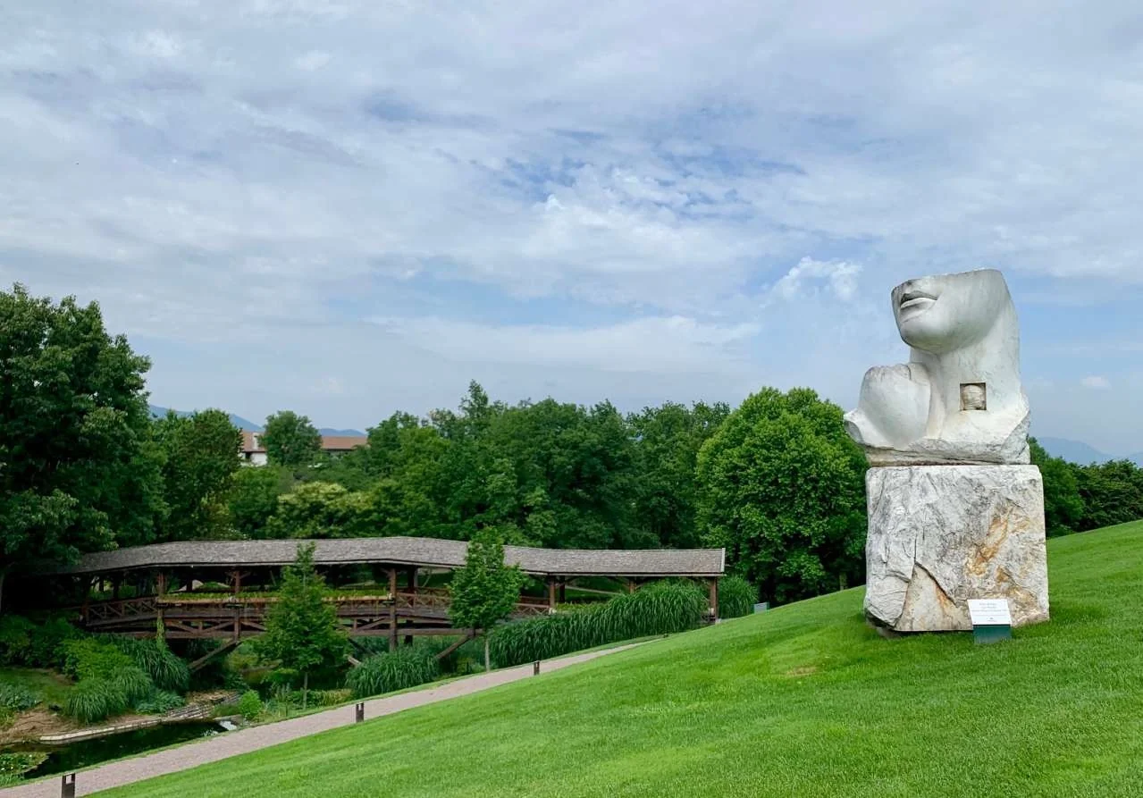 Sculpture and landscaped gardens at a Franciacorta wine estate