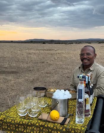 A guide serving drinks on the plains.