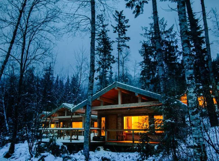 Warmly lit cedar lodge among the forest in British Columbia